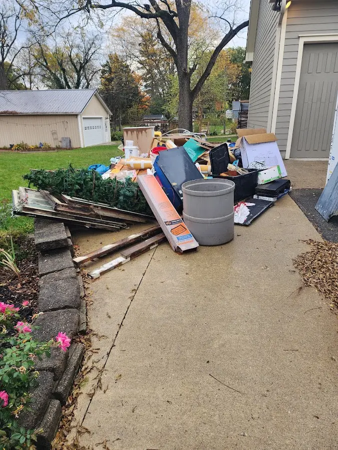 Dumpster being loaded with debris for Estate Cleanout Dumpster Rental in Bridgetown